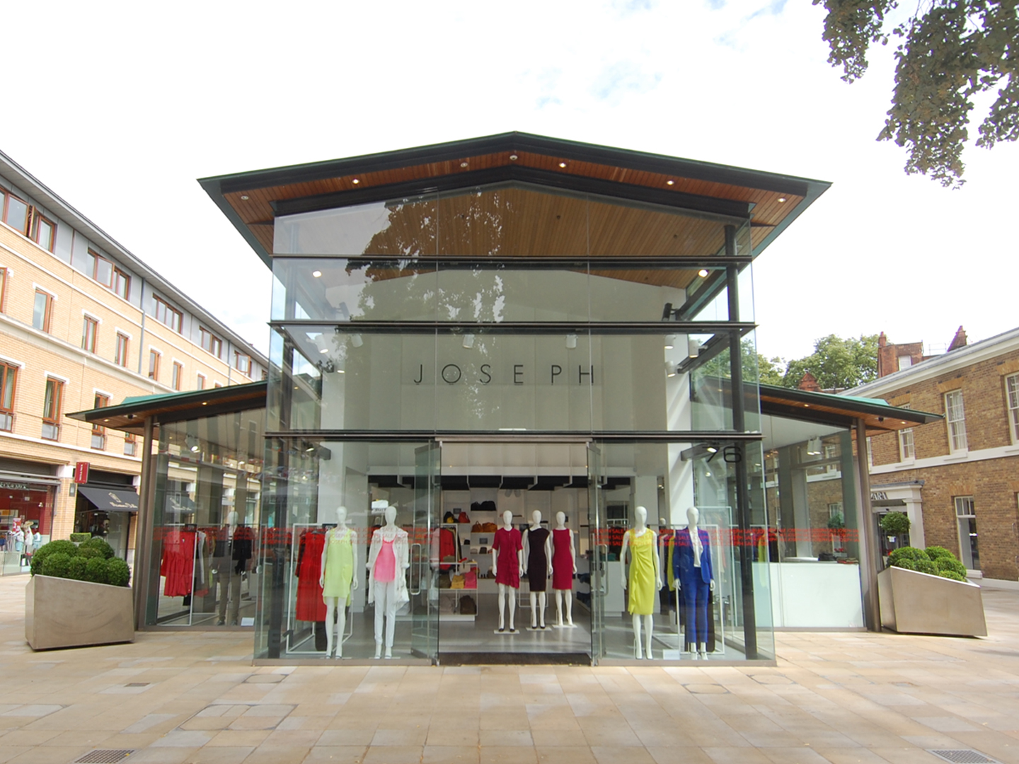 Joseph fashion boutique storefront sells women's clothing in a glass-fronted pavilion.