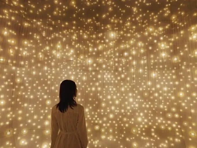 Visitor experiencing an immersive light installation at an art exhibition